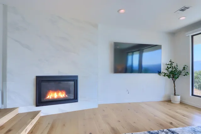 a bedroom with a bed and flat screen tv