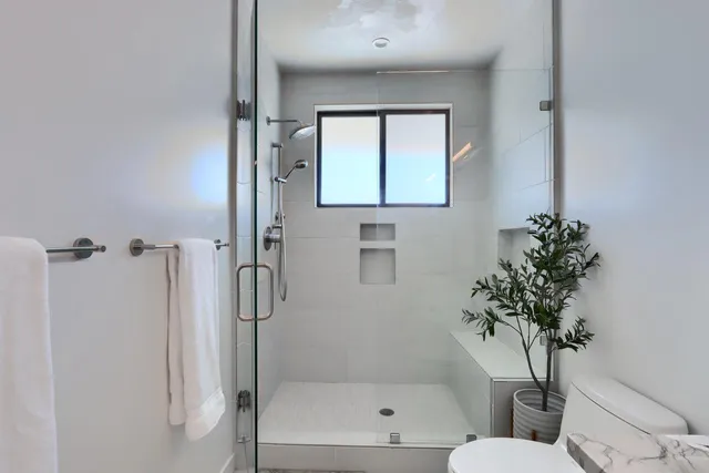 a spacious bedroom with a bed and window