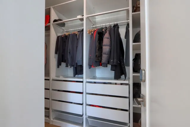 a bedroom with a bed and a chair