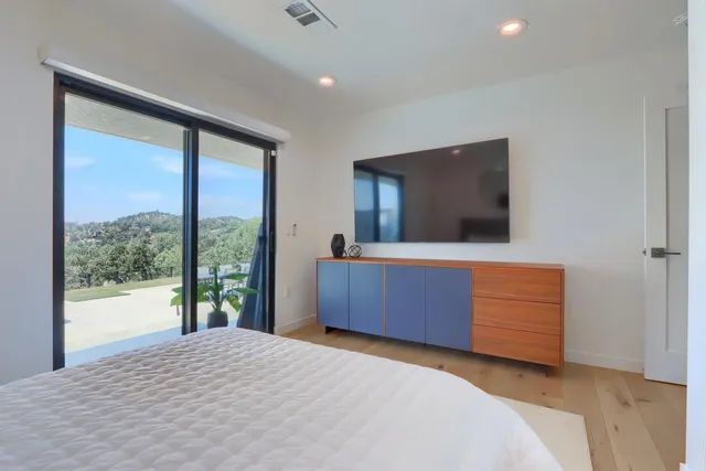 a bedroom with a bed and a mirror