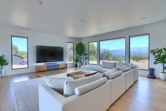 a room with pool table and windows