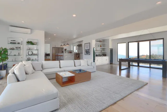 a kitchen with stainless steel appliances granite countertop a sink a stove a refrigerator and island