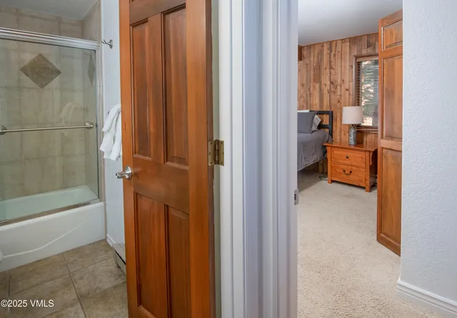 a view of a bathroom with a tub and shower