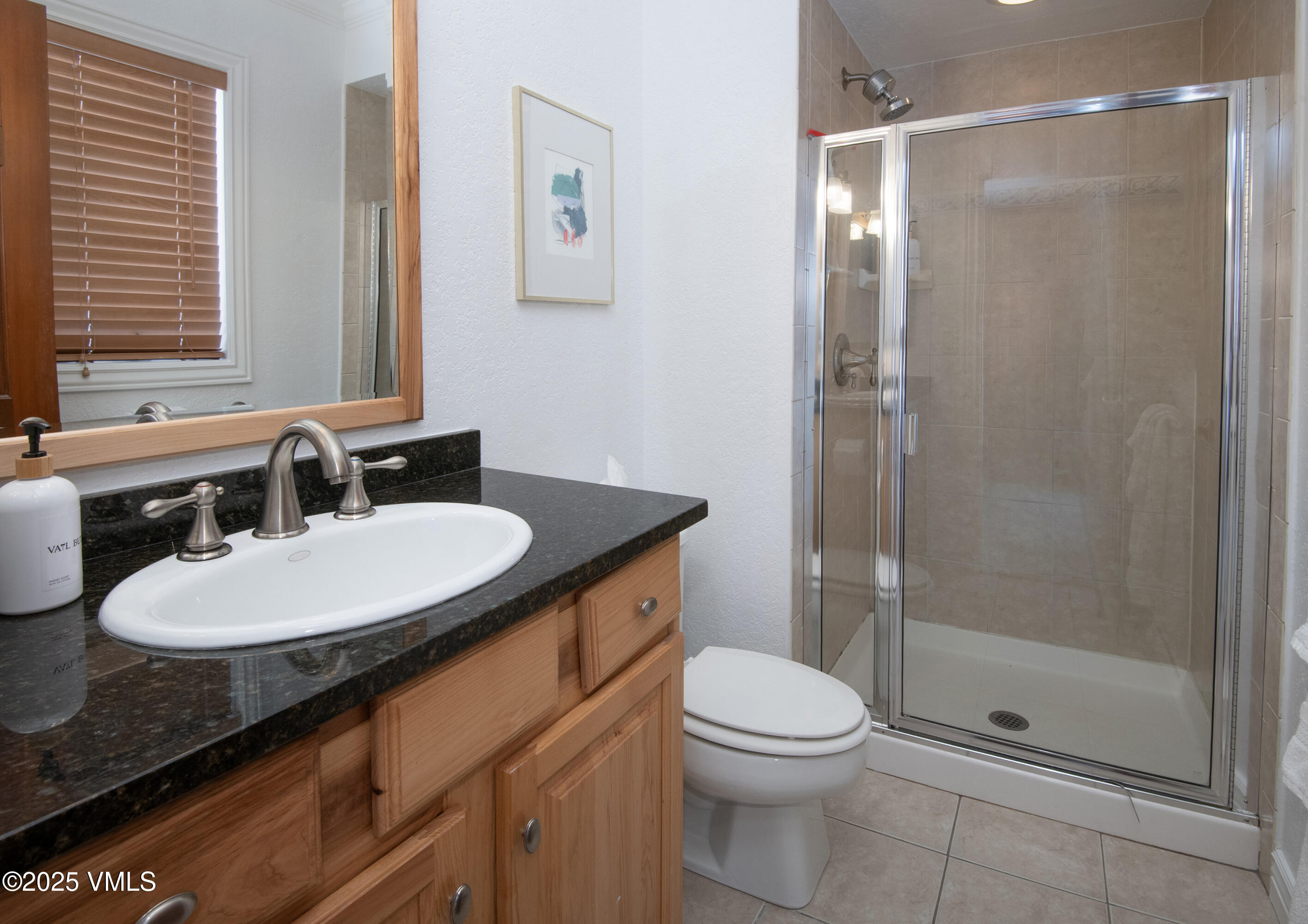 4479 Timber Falls Court, Unit 2001 Vail, CO 81657 - Photo 15 of 27 a bathroom with a sink a toilet and shower