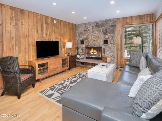 a living room with furniture a flat screen tv and a fireplace