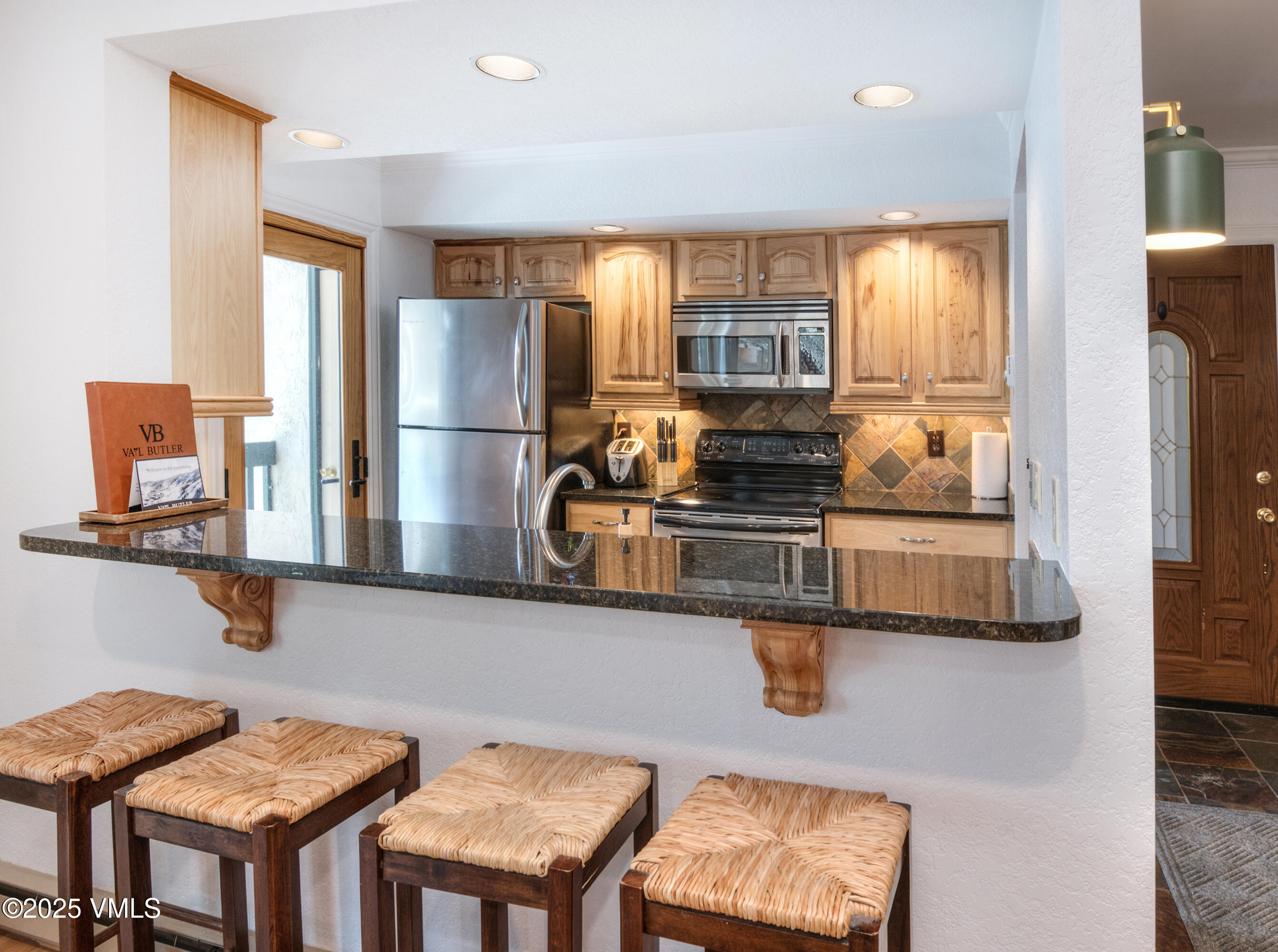 4479 Timber Falls Court, Unit 2001 Vail, CO 81657 - Photo 8 of 27 a kitchen with stainless steel appliances granite countertop a sink a stove and a refrigerator