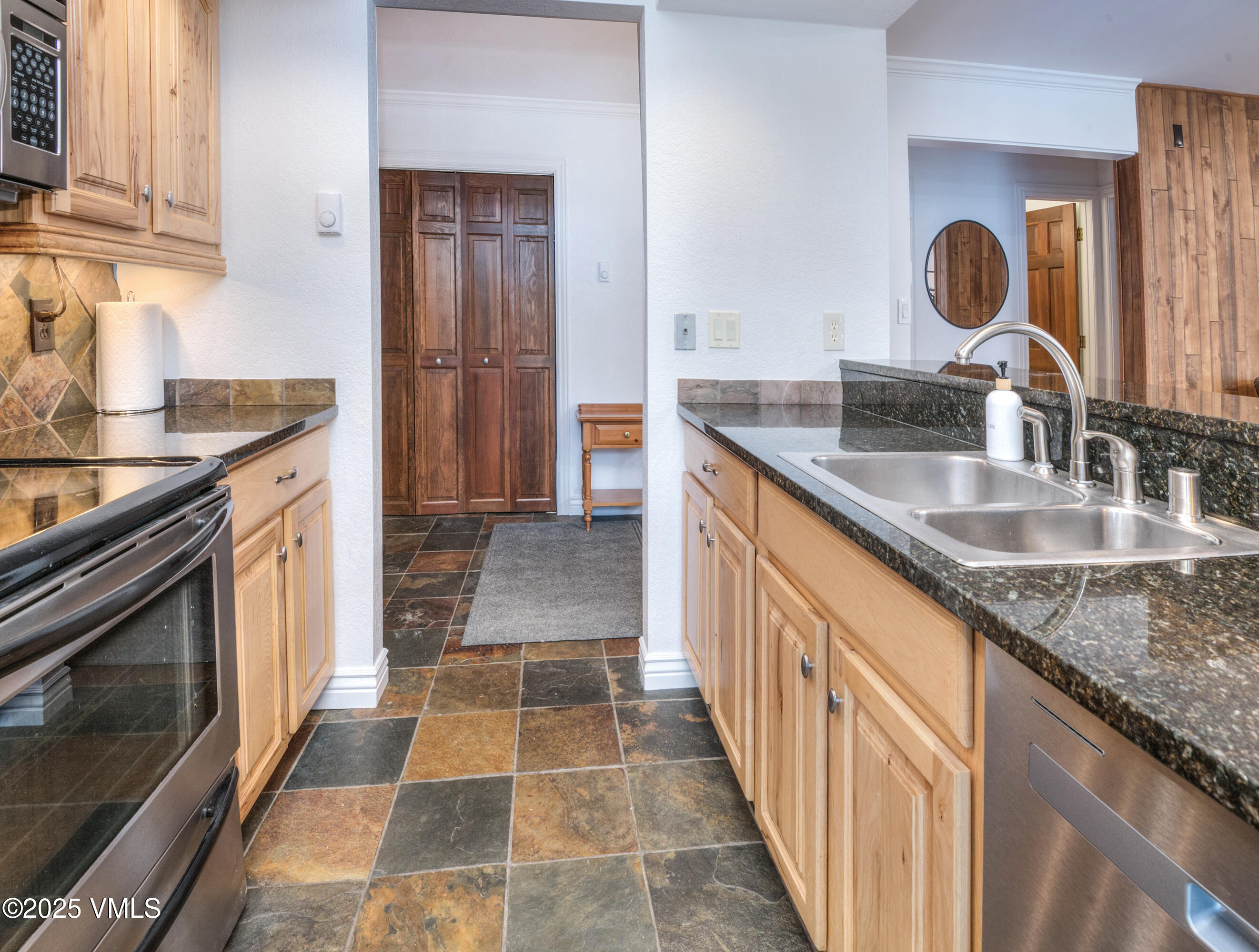 4479 Timber Falls Court, Unit 2001 Vail, CO 81657 - Photo 10 of 27 a kitchen with a sink stove and cabinets