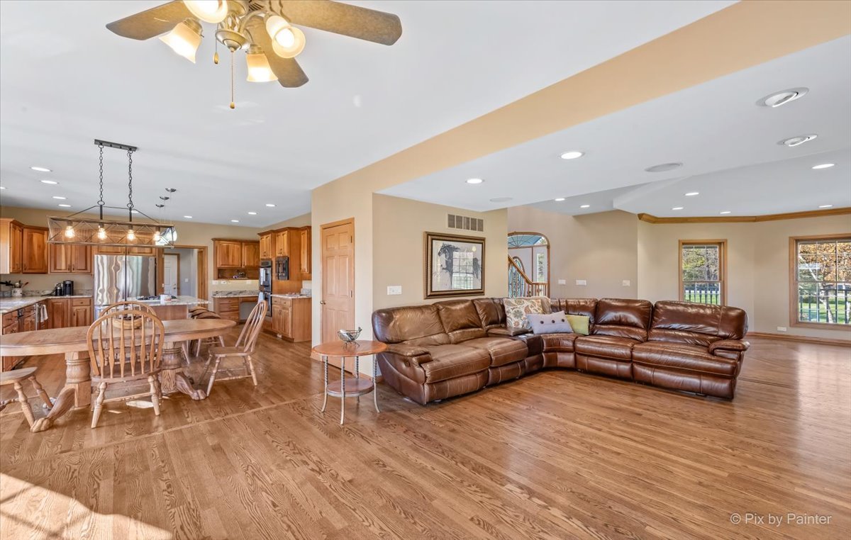 9N523 Kendall Road Elgin, IL 60124 - Photo 15 of 60 a living room with furniture a wooden floor and a chandelier