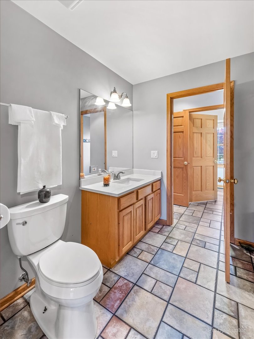 9N523 Kendall Road Elgin, IL 60124 - Photo 29 of 60 a bathroom with a sink a toilet and a mirror