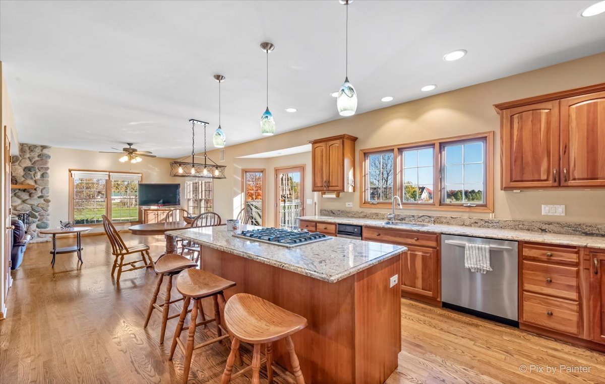 9N523 Kendall Road Elgin, IL 60124 - Photo 6 of 60 a open kitchen with stainless steel appliances granite countertop a stove a sink a oven a dining table and chairs with wooden floor