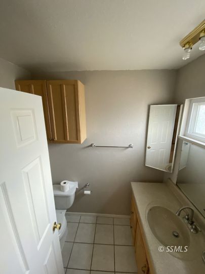 519 South Fairview Street Ridgecrest, CA 93555 - Photo 17 of 20 a bathroom with a sink a toilet and mirror