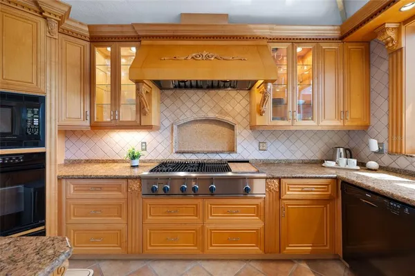 a view of a room with wooden floor and ceiling fan