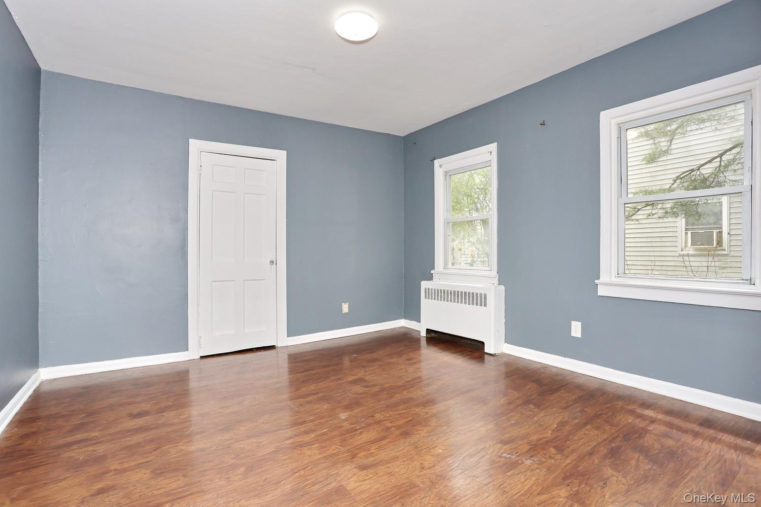 29 Fairview Avenue Spring Valley, NY 10977 - Photo 8 of 19 a view of an empty room with wooden floor and a window