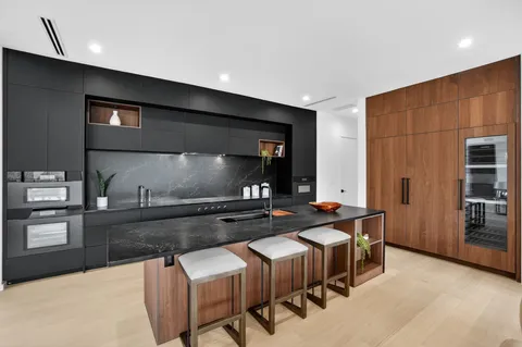 a kitchen with stainless steel appliances granite countertop a sink and a stove