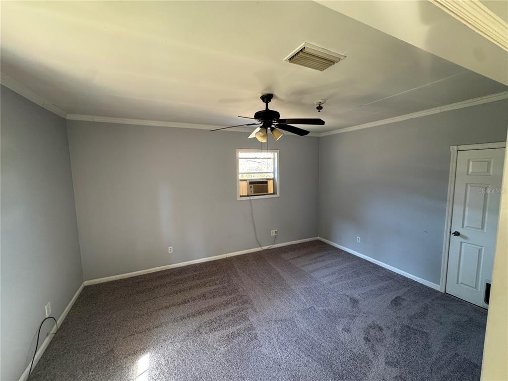 301 Hickory Lane Seffner, FL 33584 - Photo 13 of 14 an empty room with a window and a ceiling fan