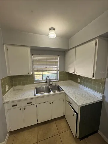a kitchen with a sink and cabinets