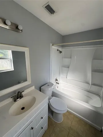 a bathroom with a sink mirror vanity and toilet
