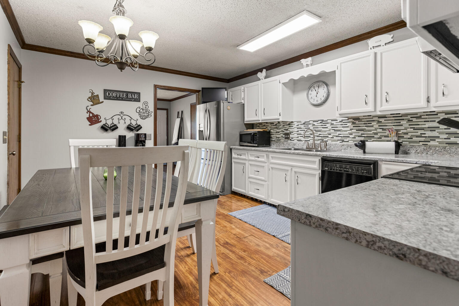 2717 East Main Street Decatur, IL 62521 - Photo 11 of 31 a kitchen with stainless steel appliances kitchen island granite countertop a stove a sink and a white cabinets