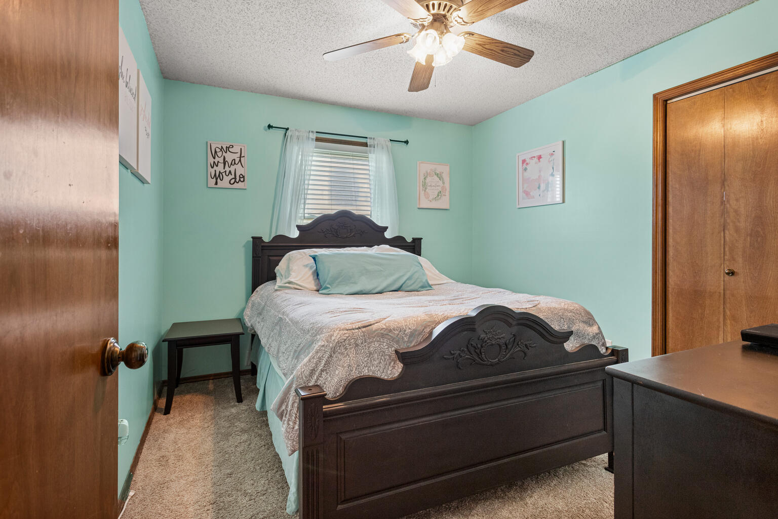 2717 East Main Street Decatur, IL 62521 - Photo 20 of 31 a bedroom with a bed and a chandelier