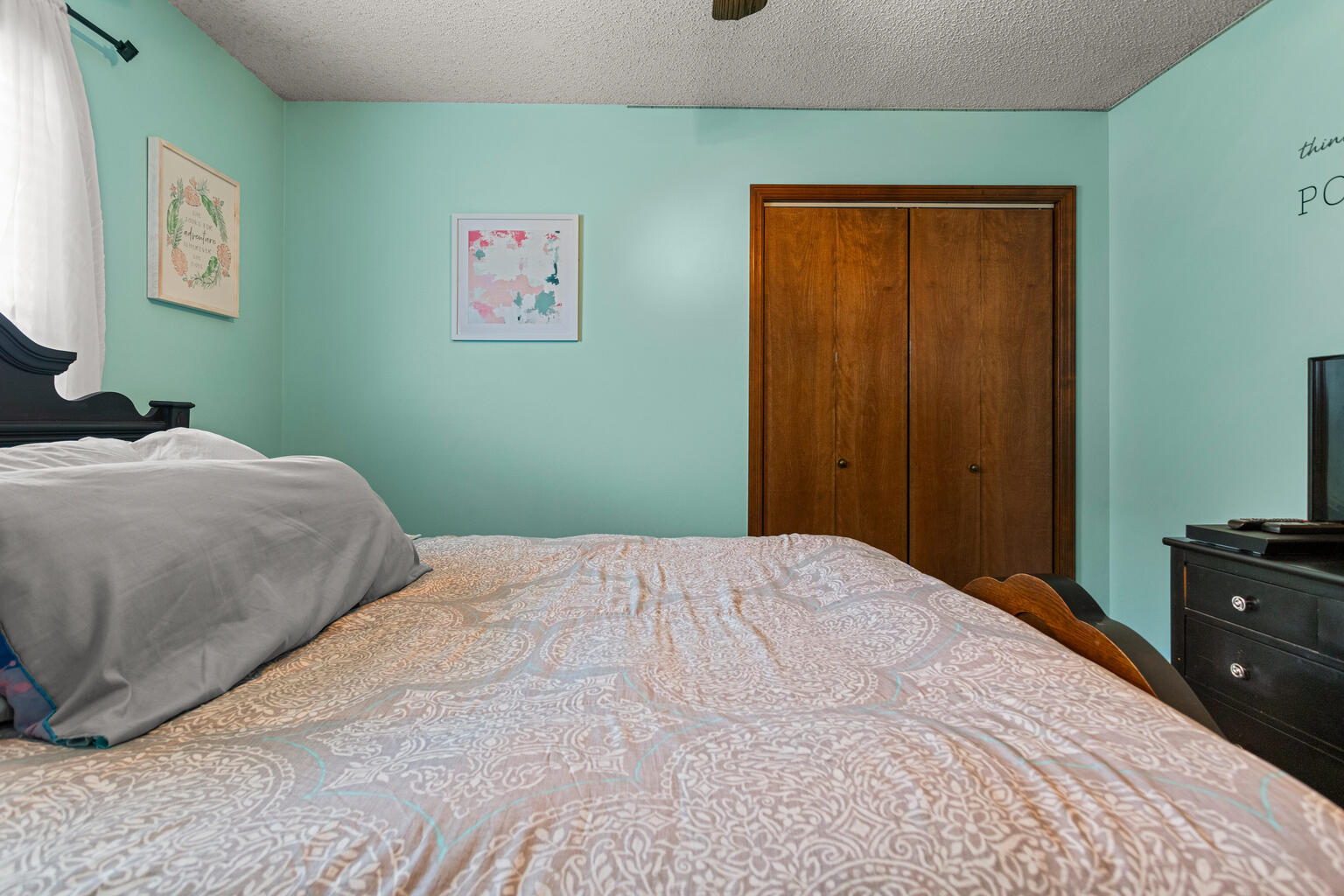 2717 East Main Street Decatur, IL 62521 - Photo 21 of 31 a bedroom with a bed and a lamp on dresser
