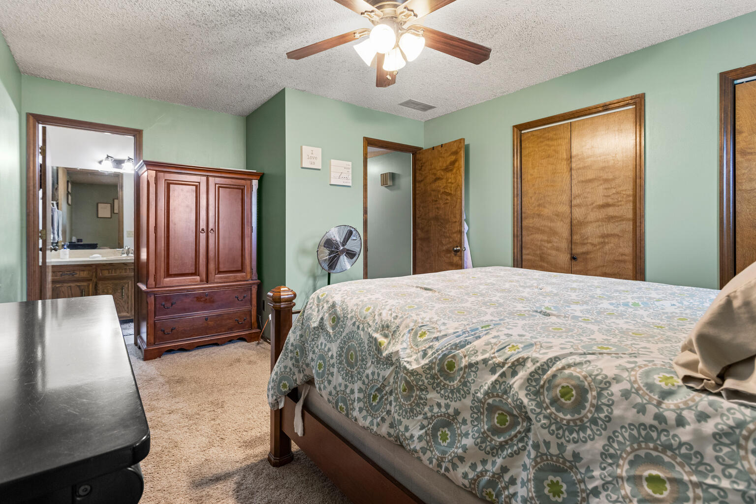 2717 East Main Street Decatur, IL 62521 - Photo 23 of 31 a bedroom with a large bed and a chandelier