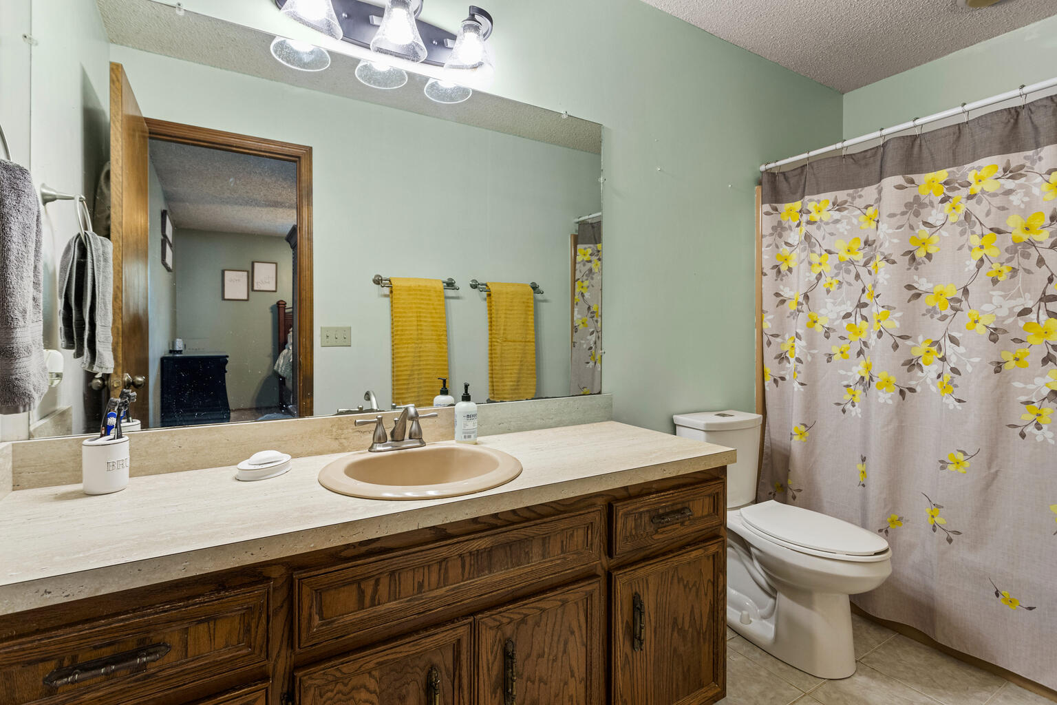 2717 East Main Street Decatur, IL 62521 - Photo 25 of 31 a bathroom with a sink a toilet a shower and a mirror