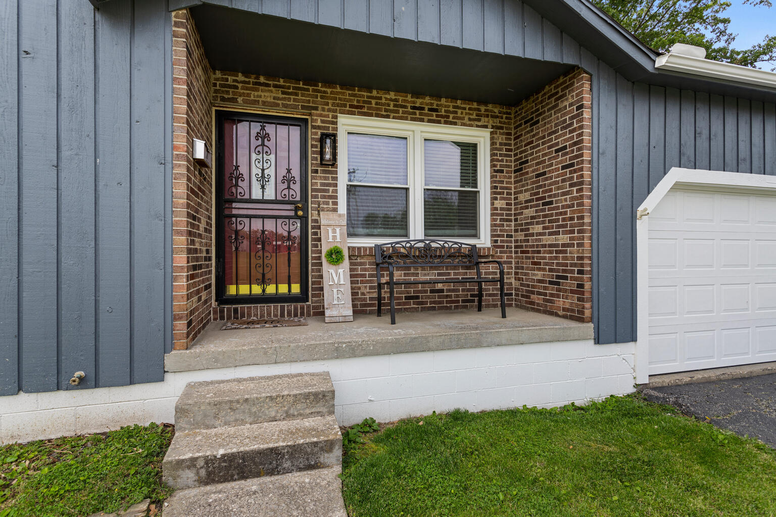 2717 East Main Street Decatur, IL 62521 - Photo 4 of 31 a front view of a house with garden