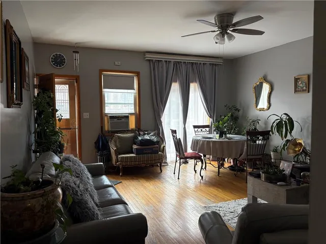 a living room with furniture fireplace and a large window