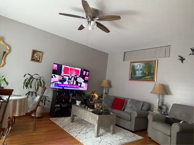 a living room with furniture a rug and a lamp