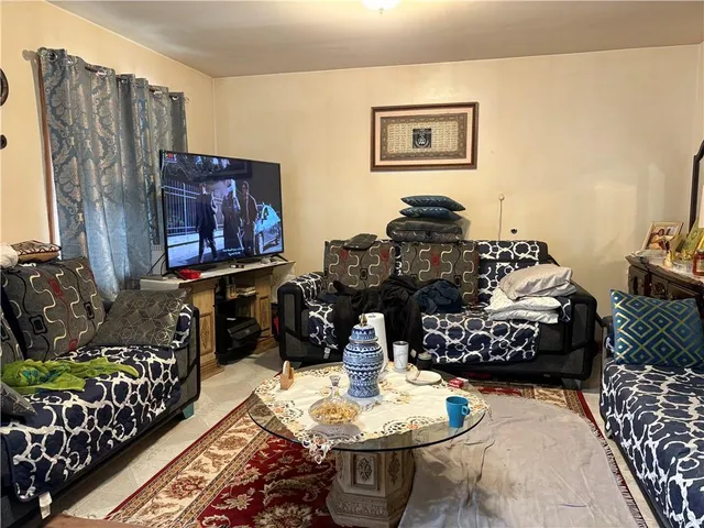 a living room with furniture and painting on the wall