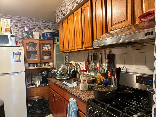 a kitchen with a sink and a stove top oven