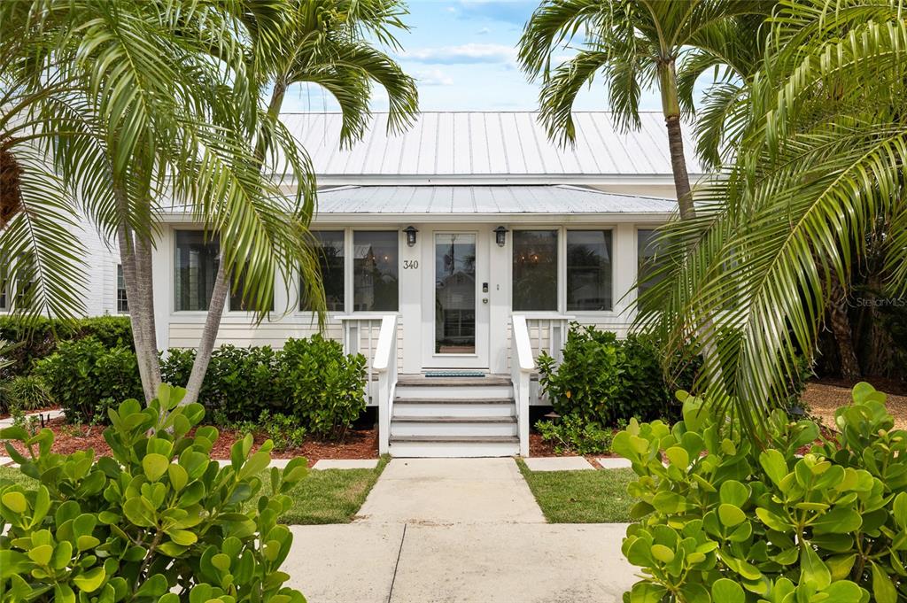 340 Palm Avenue Boca Grande, FL 33921 - Photo 5 of 38 a front view of a house with a garden
