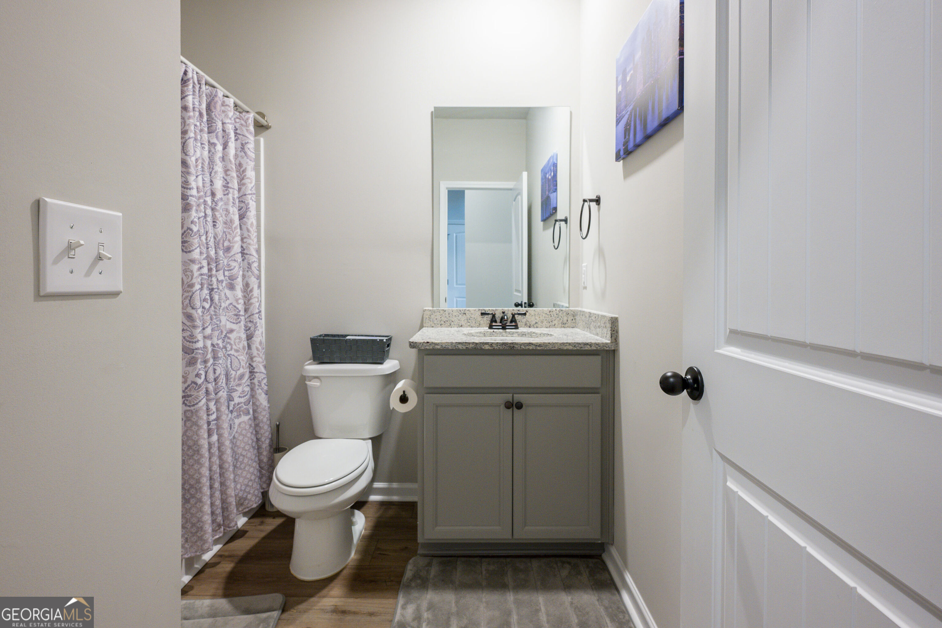 10155 Cormac Street Jonesboro, GA 30238 - Photo 18 of 40 a white toilet sitting next to a bathroom sink