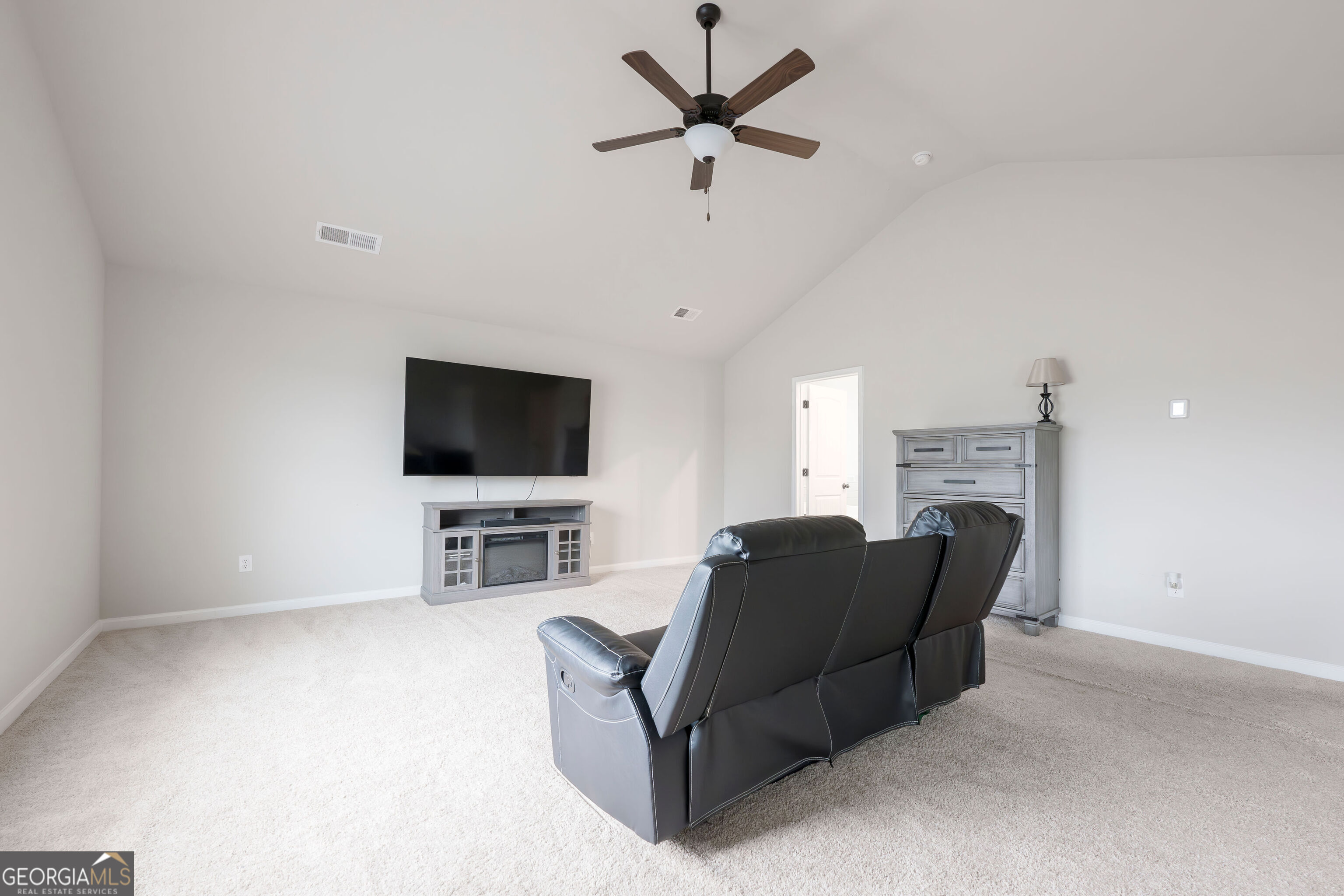 10155 Cormac Street Jonesboro, GA 30238 - Photo 20 of 40 a living room with furniture and a flat screen tv