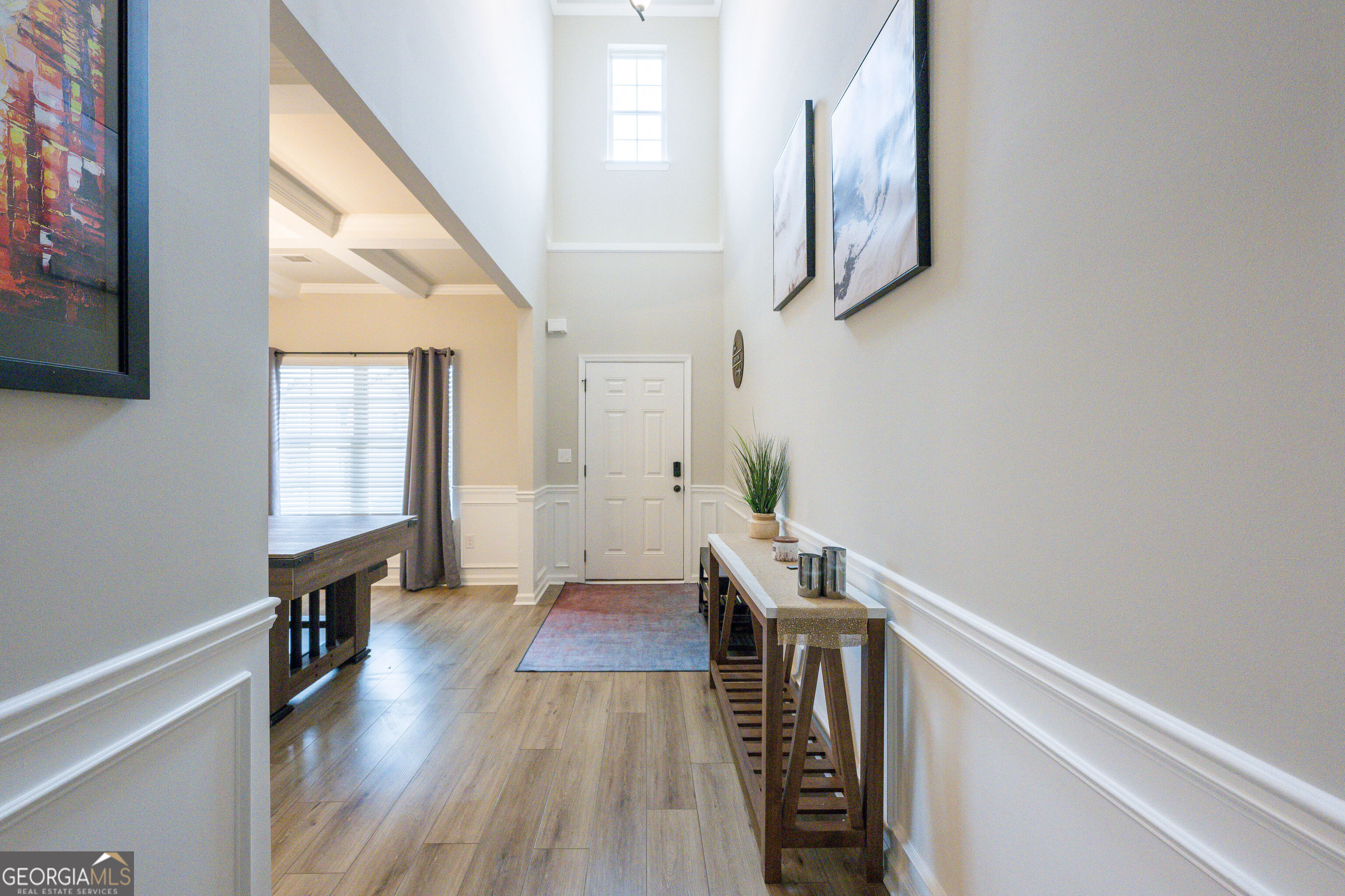 10155 Cormac Street Jonesboro, GA 30238 - Photo 2 of 40 a view of a hallway with wooden floor and staircase