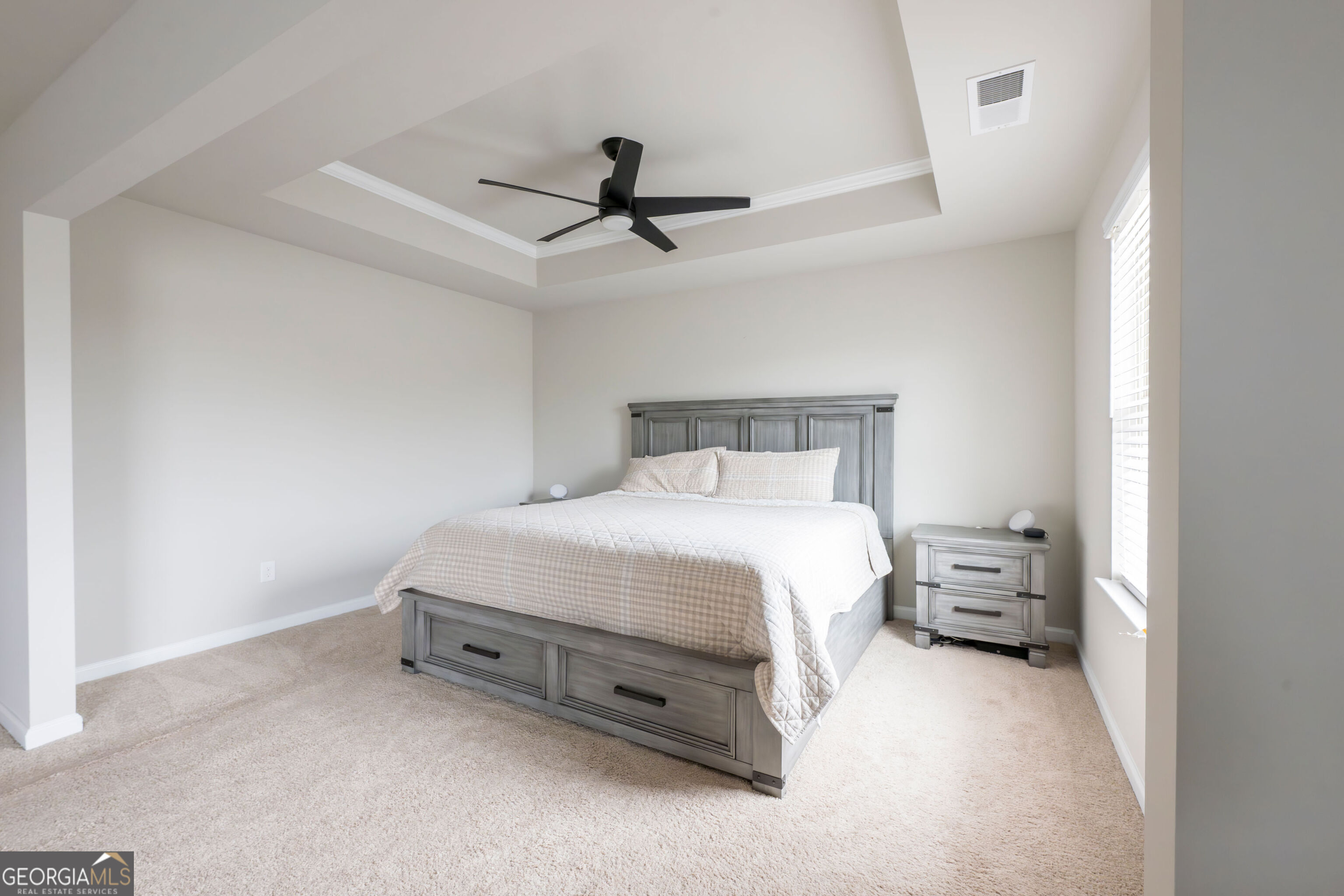 10155 Cormac Street Jonesboro, GA 30238 - Photo 23 of 40 a bedroom with a bed and a ceiling fan