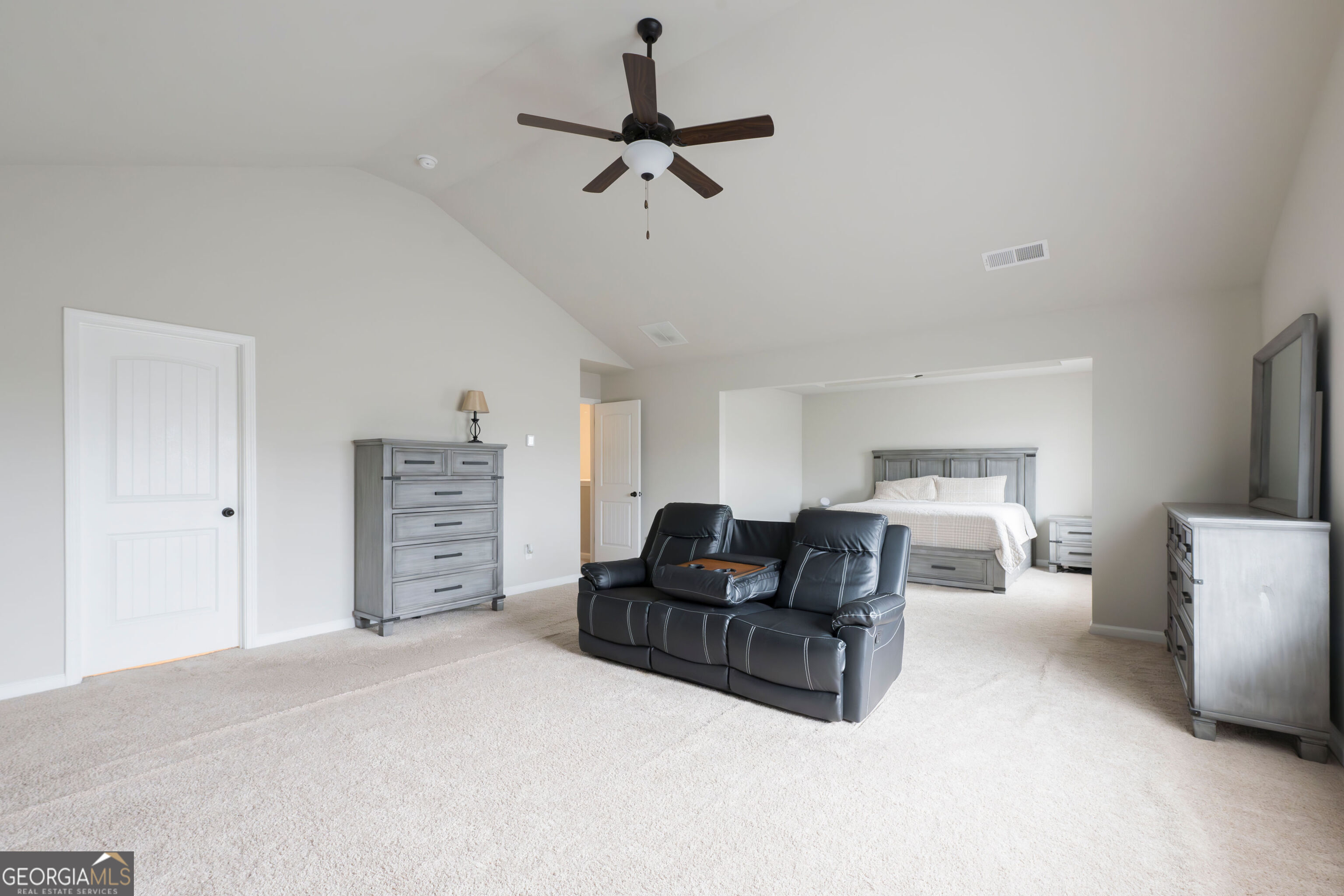 10155 Cormac Street Jonesboro, GA 30238 - Photo 24 of 40 a living room with furniture a ceiling fan and a rug