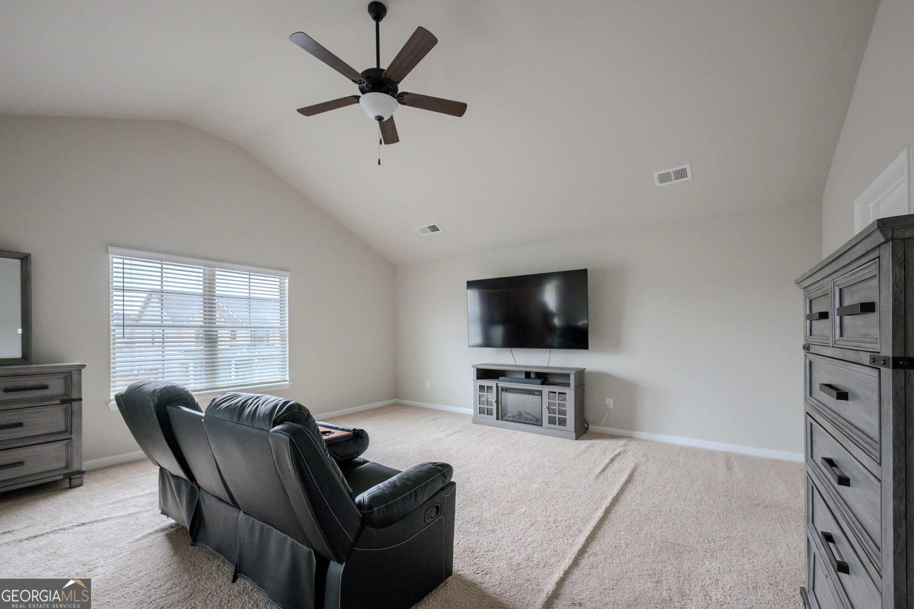 10155 Cormac Street Jonesboro, GA 30238 - Photo 25 of 40 a living room with furniture and a flat screen tv