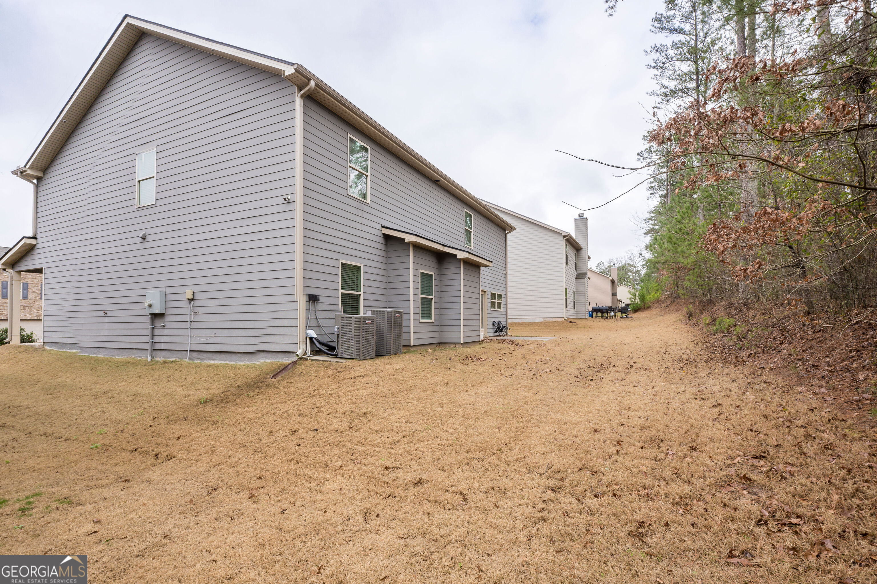 10155 Cormac Street Jonesboro, GA 30238 - Photo 40 of 40 a view of a house with a yard and garage