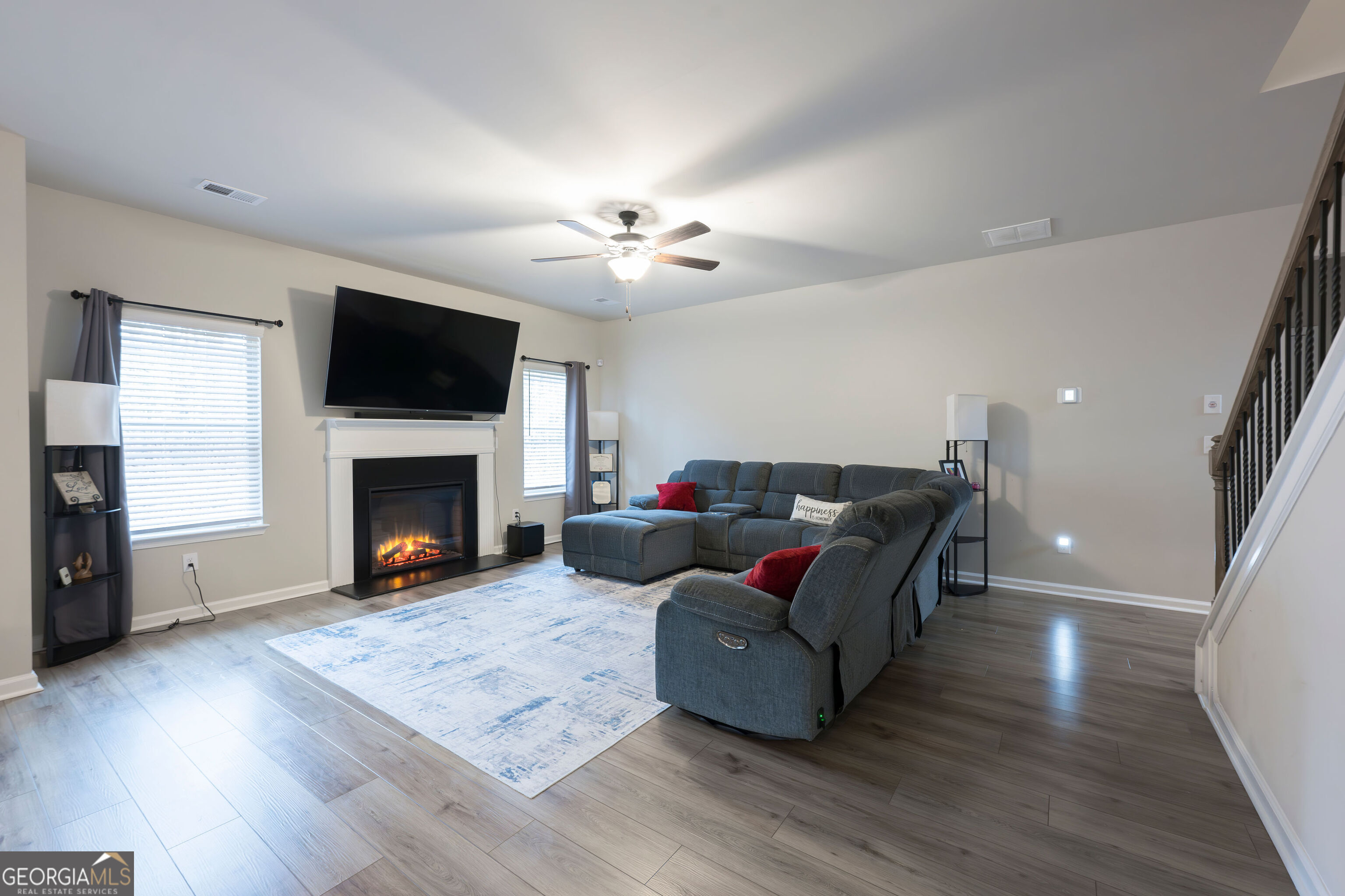 10155 Cormac Street Jonesboro, GA 30238 - Photo 7 of 40 a living room with furniture a flat screen tv and a fireplace