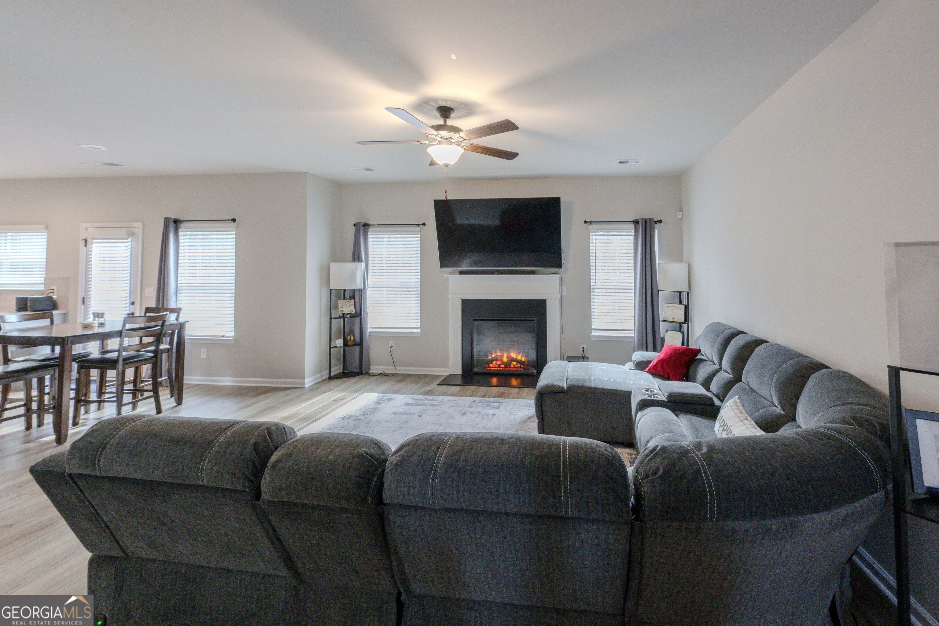 10155 Cormac Street Jonesboro, GA 30238 - Photo 9 of 40 a living room with furniture a flat screen tv and a fireplace