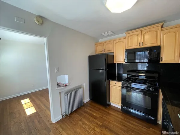 a kitchen with a refrigerator and a stove top oven