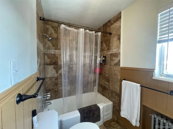 a bathroom with a shower and a tub