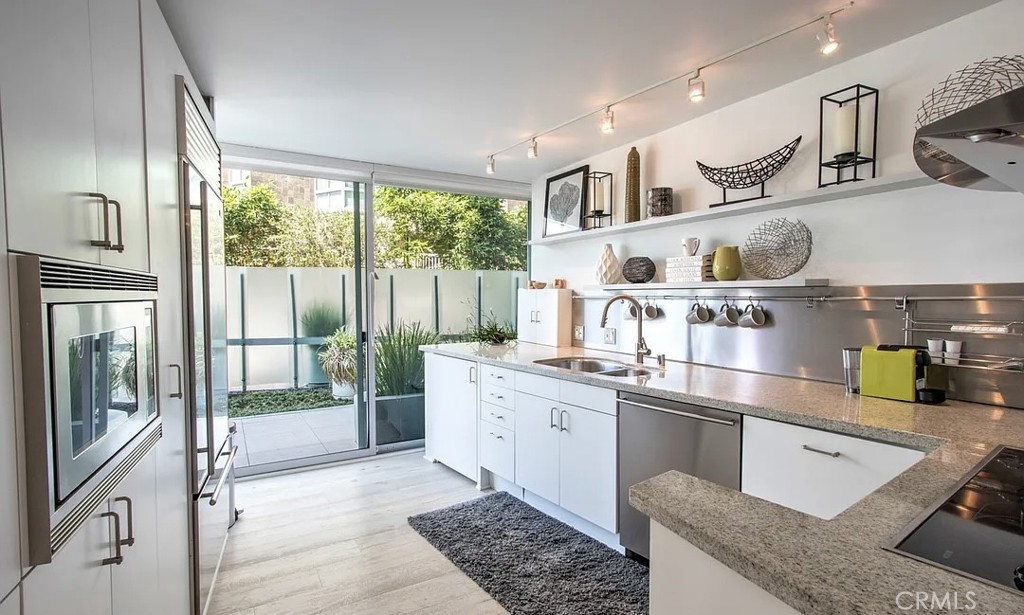 535 Ocean Santa Monica, CA 90402 - Photo 22 of 39 a kitchen with stainless steel appliances granite countertop a sink and a refrigerator