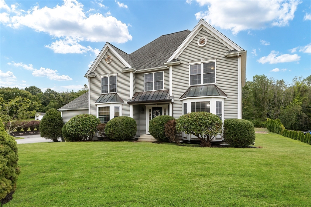 a front view of a house with a yard