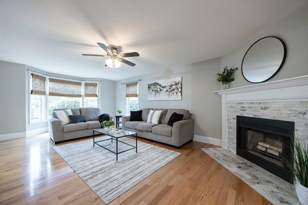 85 Sheldonville Road North Attleboro, MA 02760 - Photo 11 of 42 a living room with furniture a fireplace a window and a chandelier