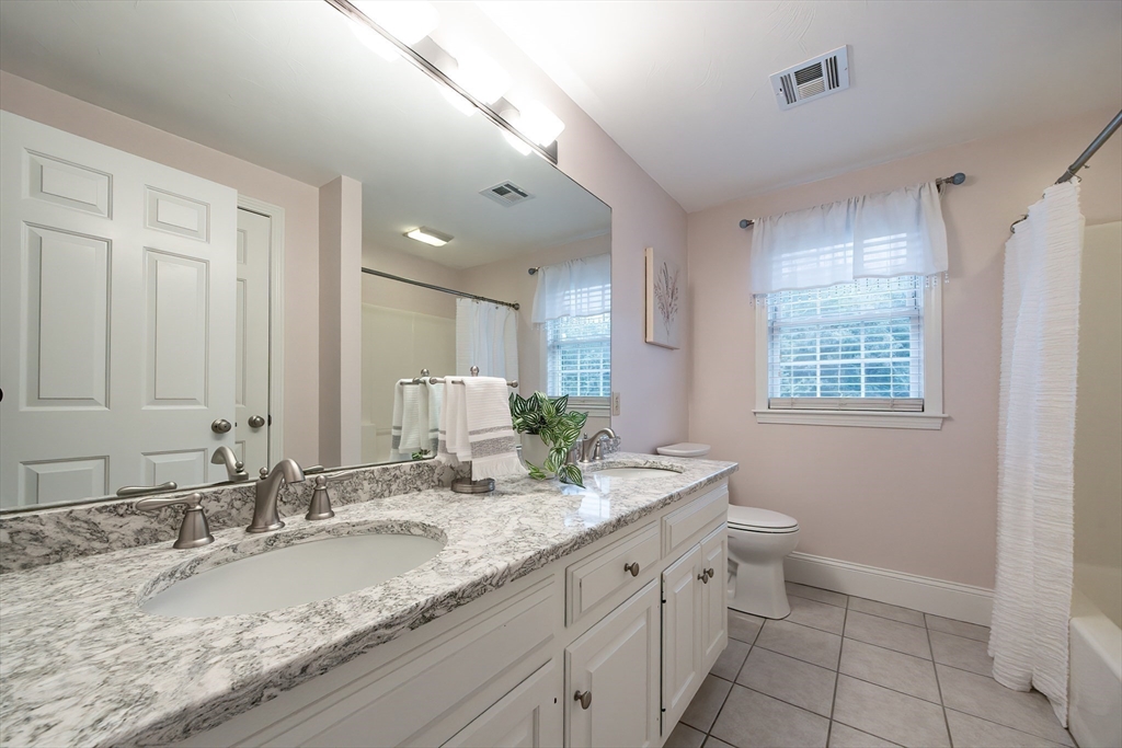 85 Sheldonville Road North Attleboro, MA 02760 - Photo 34 of 42 a bathroom with a granite countertop sink mirror and a toilet