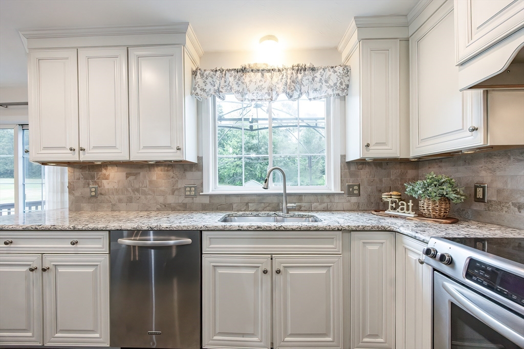 85 Sheldonville Road North Attleboro, MA 02760 - Photo 4 of 42 a kitchen with granite countertop white cabinets and white appliances