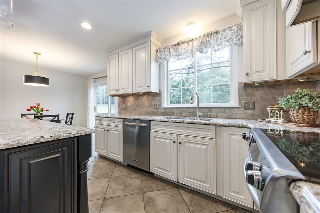 85 Sheldonville Road North Attleboro, MA 02760 - Photo 5 of 42 a kitchen with granite countertop cabinets stainless steel appliances a sink and a window