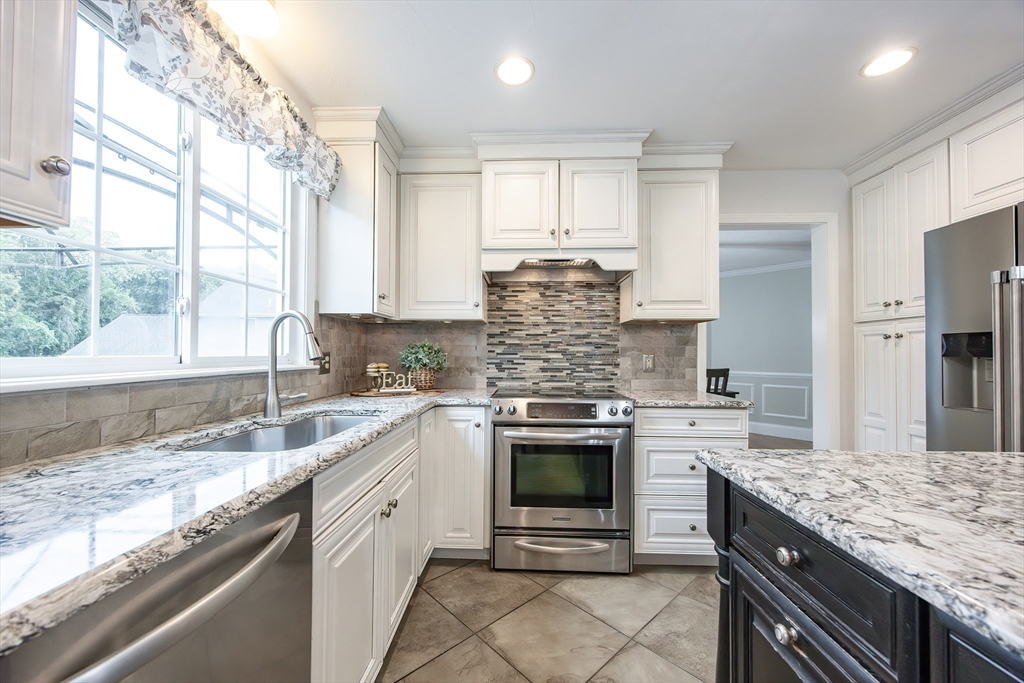 85 Sheldonville Road North Attleboro, MA 02760 - Photo 7 of 42 a kitchen with stainless steel appliances granite countertop a sink stove and refrigerator